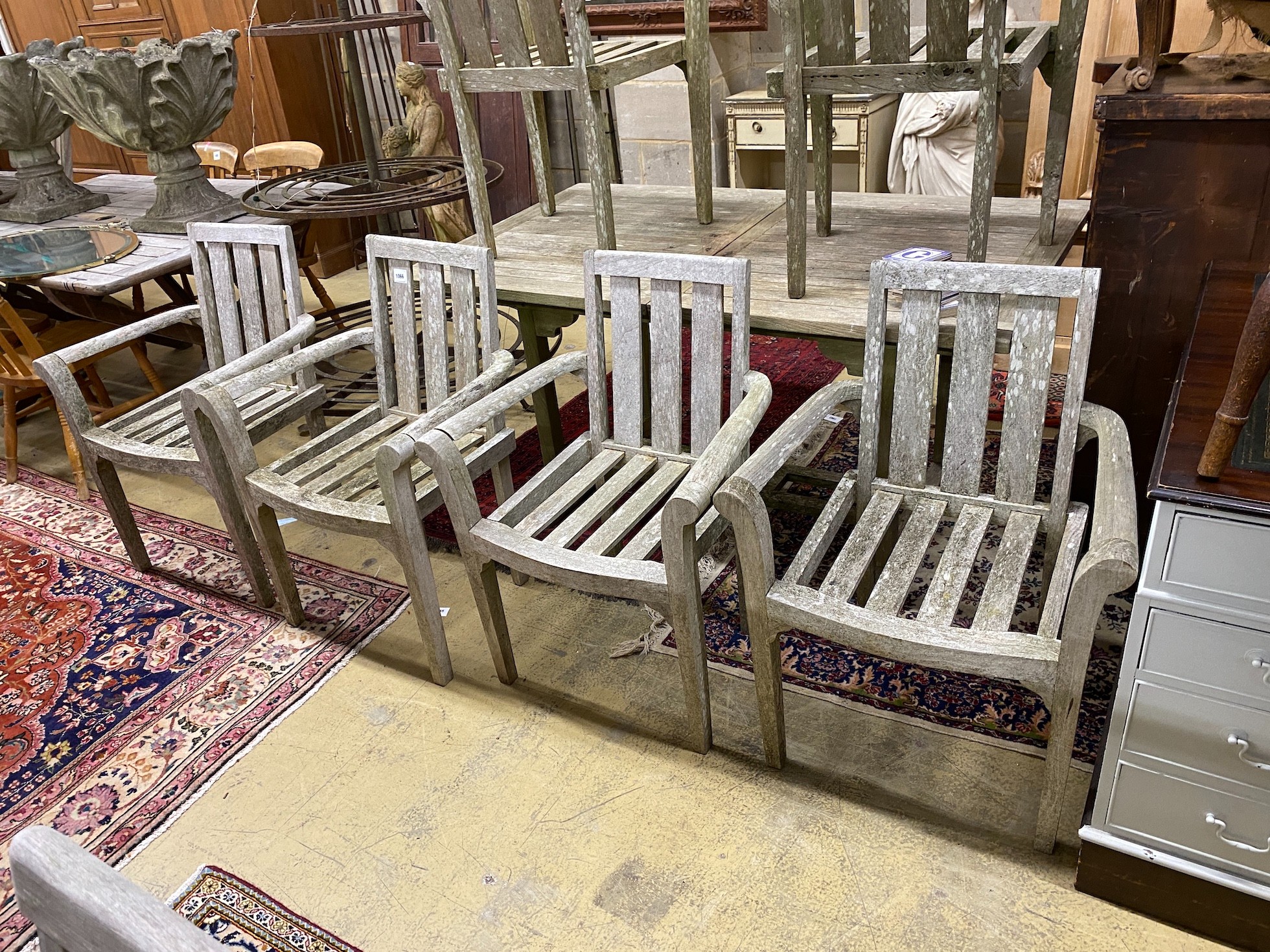 A weathered teak extending table, length 150cm, 90cm unextended and six teak chairs